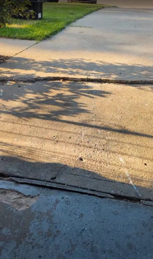 Raised concrete lip at the garage before correction