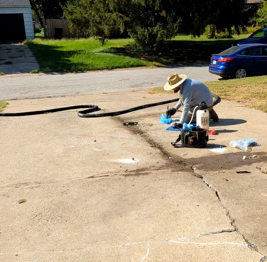 KC Lift & Level injecting polyurethane foam beneath the driveway